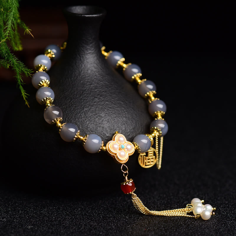 Armband Achat Perle Fu-Zeichen – Balance mit goldenen Verzierungen elegant.