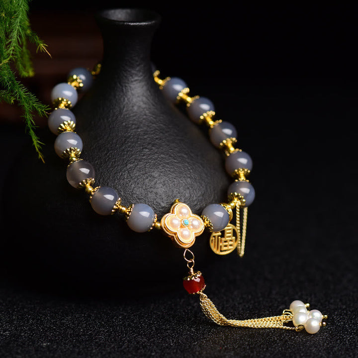 Armband Achat Perle Fu-Zeichen – Balance mit goldenen Verzierungen elegant.