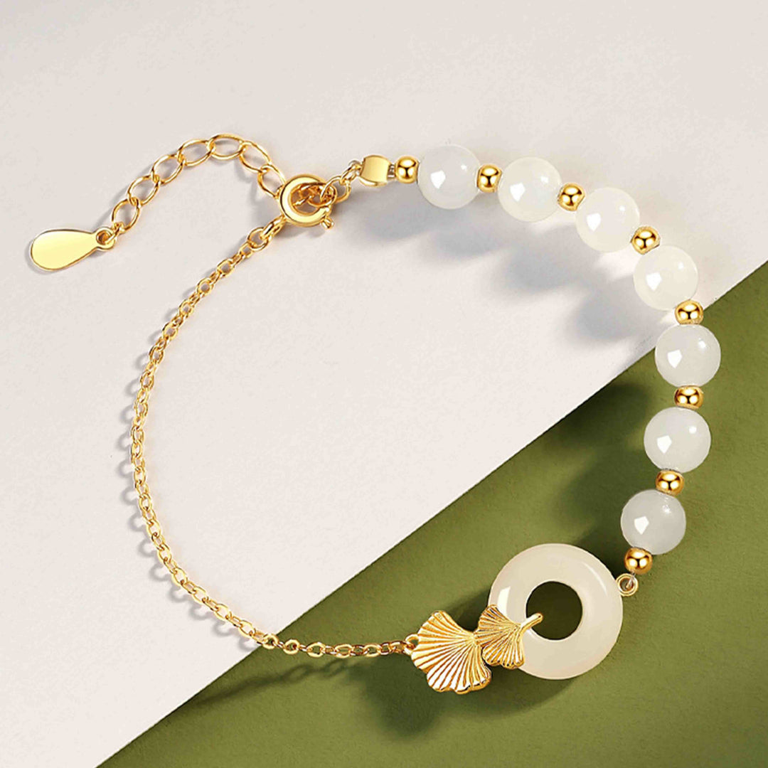 Armband 925 Silber weiße Jade Perlen goldfarbene Ginkgo Blatt Anhänger elegant.