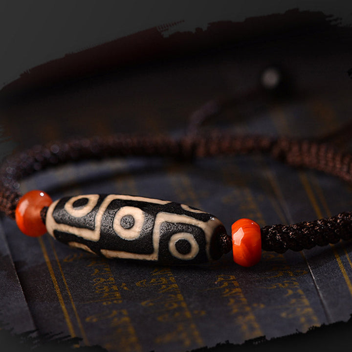 Armband Dzi-Perle Neun Augen auf schwarzem Stoff, weiße schwarze Perle rote Achat Kugeln elastisch.