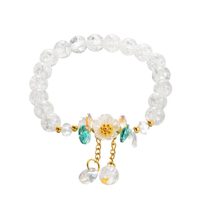 Armband Blume Glas mit grünen Steinen und goldenen Perlen elegant.