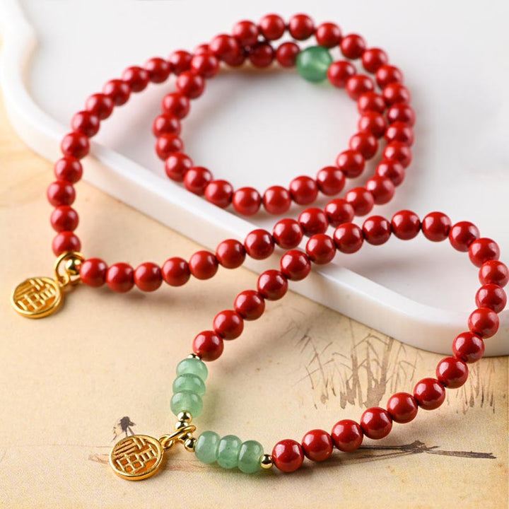 Armband Grüner Aventurin Zinnober rote Perlen goldene Verschlüsse Glück.