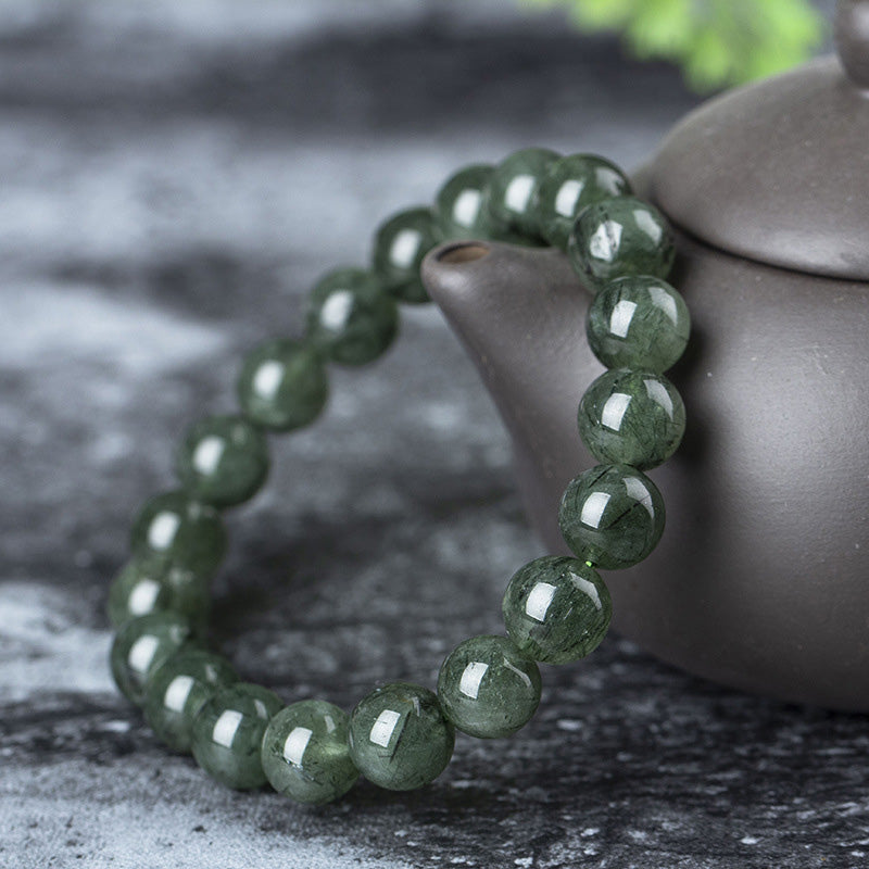 Grünes Kristall Armband Armband Kristall – Wohlstand & Segen neben Keramik