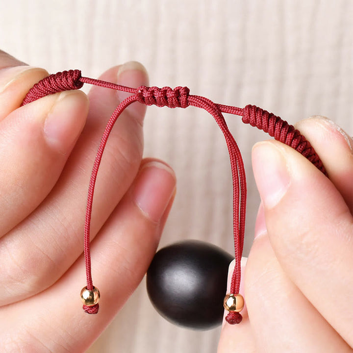 Rotes Armband mit schwarzer Ebenholz Kugel Katze Frieden elastisch
