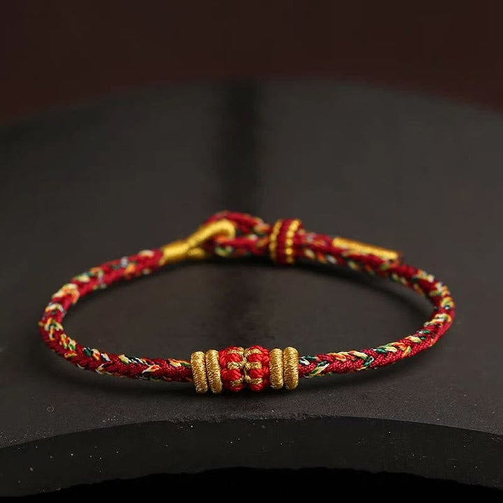 Rotes gold geflochtenes Armband Bunt Glück Knoten elegant.