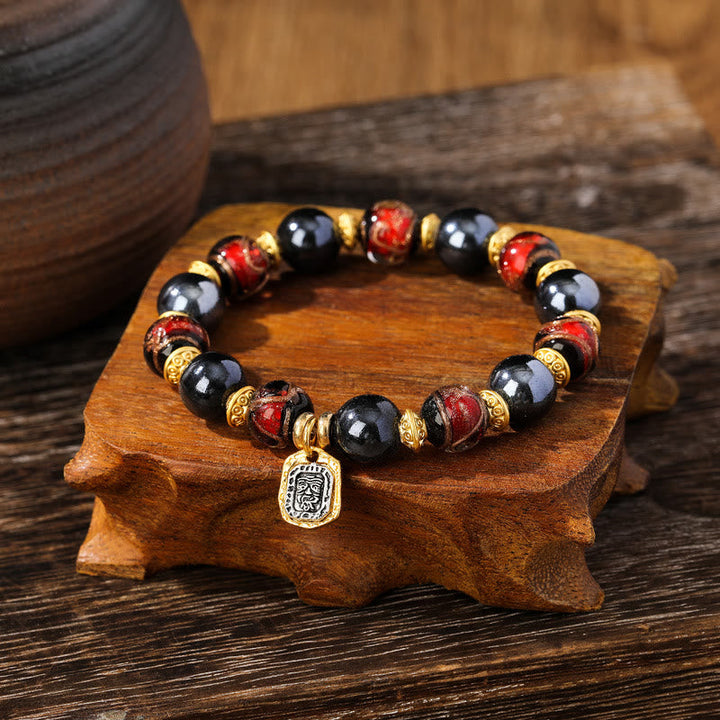 Armband Zakiram schwarze Obsidian rote Perlen goldene Spacer Anhänger