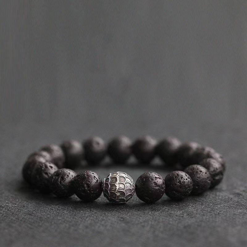 Armband Lavastein – Heilung mit silbernem Mittelpunkt schwarze Perlen