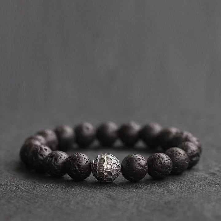 Armband Lavastein – Heilung mit silbernem Mittelpunkt schwarze Perlen
