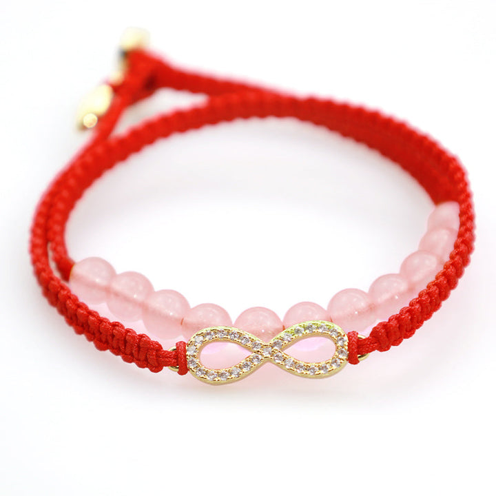 Rotes Armband Kristall Lotus mit rosa Quarzperlen und Infinity-Charm.