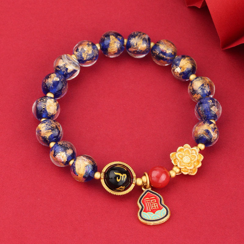 Armband Om Mani Padme Hum – Glück mit blauen Perlen goldenen Akzenten.