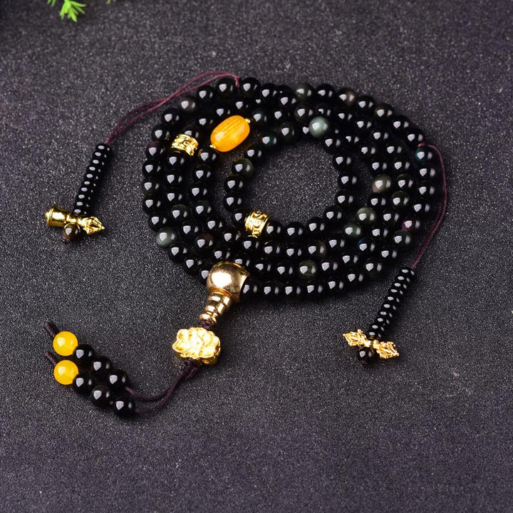 Armband Schwarzer Obsidian mit goldenen Perlen und gelben Steinen elastisch.