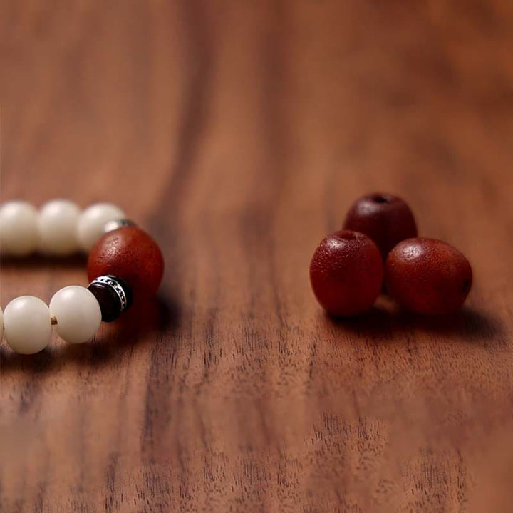 Mala Achat Bodhi – Wohlstand Armband mit roten und weißen Perlen Holz.