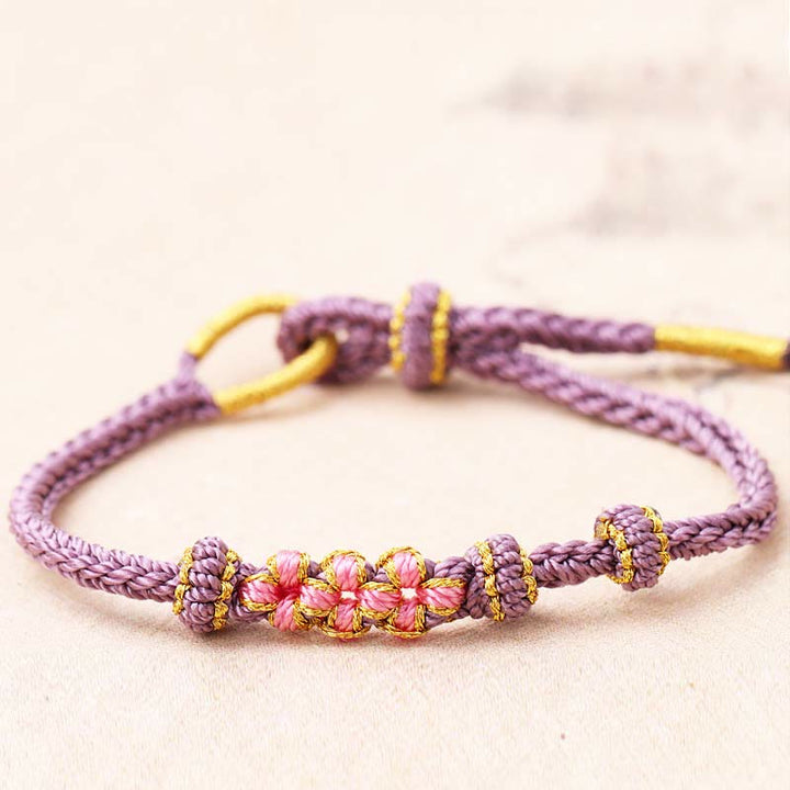 Armband Pfirsichblüte – Glück lila Seil elastisch Perlen golden verziert