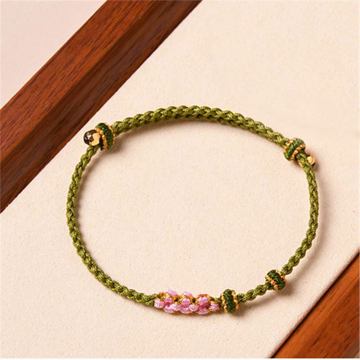 Grünes Armband mit rosa Pfirsichblüte – Schutz elastisch geflochten