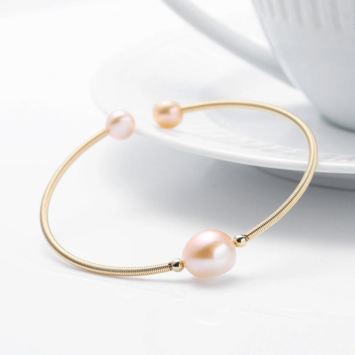 Goldenes Armband Perle – Wohlstand mit rosafarbener Perle elegant.
