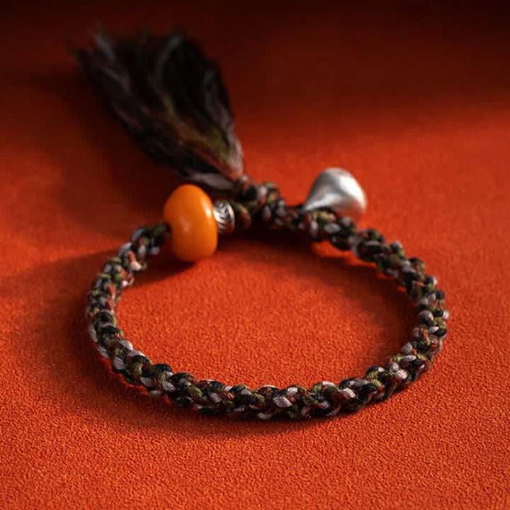 Geflochtenes Armband 925 Silber – Schutz mit orangem Stein und Quasten.