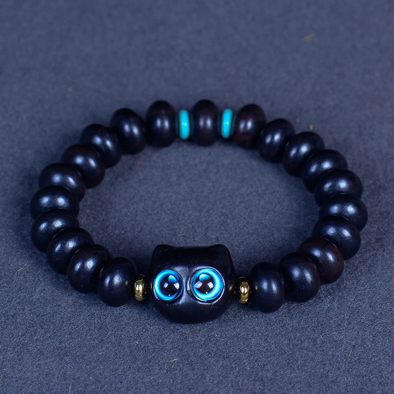 Armband Ebenholz Katze mit blauen Augen und Goldperlen elastisch.