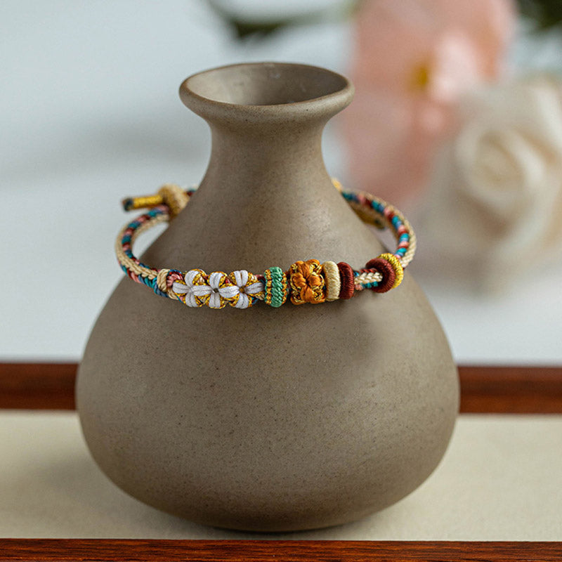 Armband Pfirsichblüte mit bunten Perlen beige Keramik Vase Dekoration