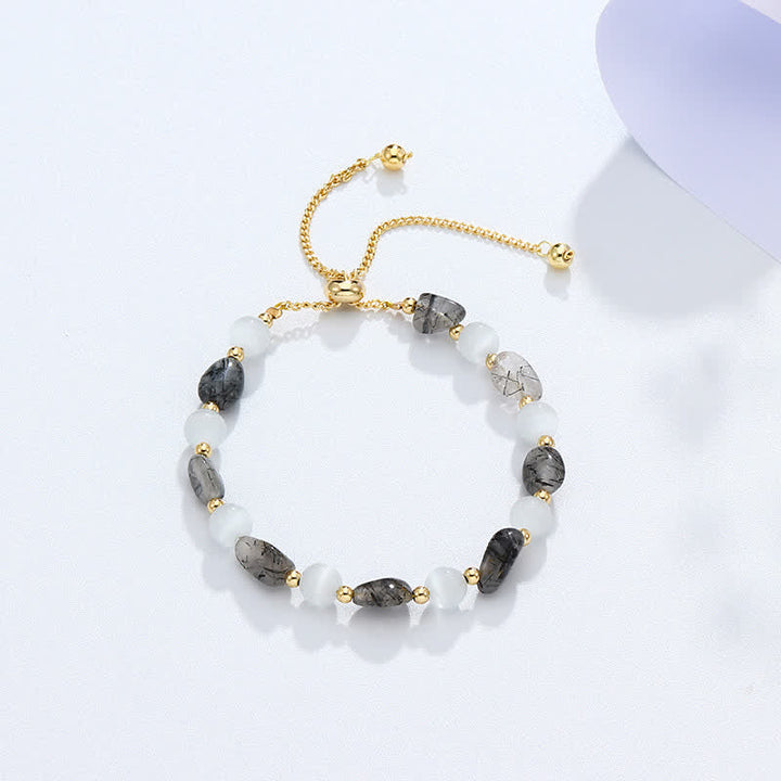 Armband mit Turmalin und Mondstein Perlen goldene Kettenglieder verstellbar.