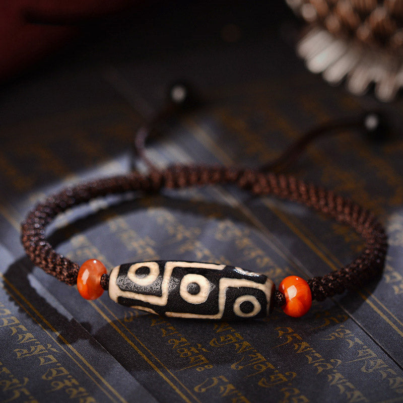 Armband Dzi-Perle Neun Augen auf Buch flach dunkelbraun orange Perlen