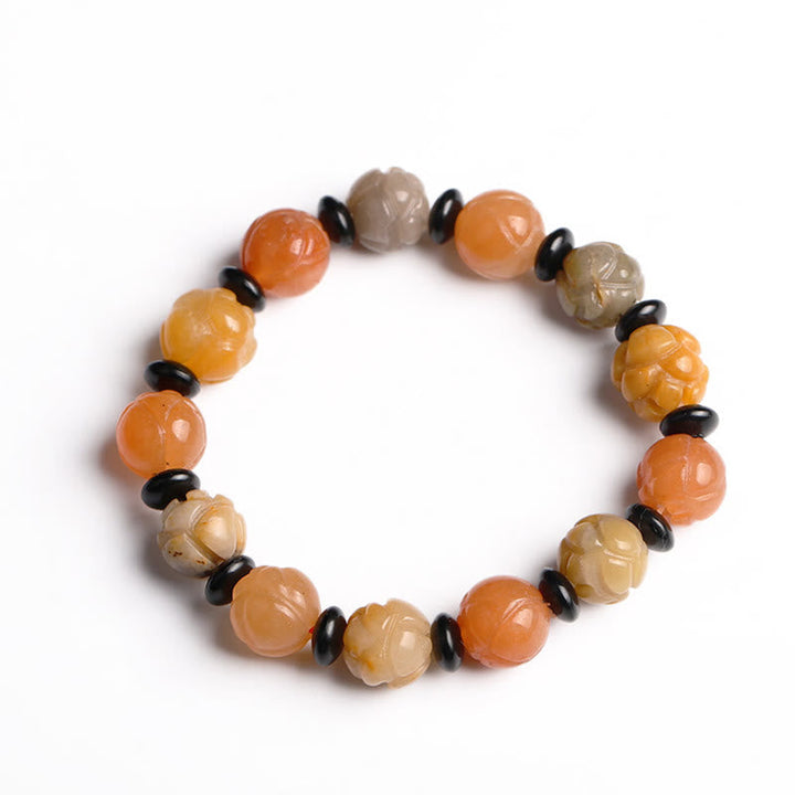 Armband Jade Lotus mit orange Perlen und schwarzen Akzenten elastisch