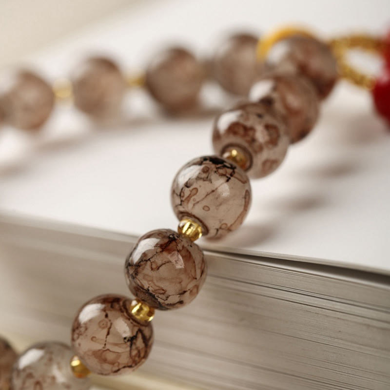 Armband – Harmonie & Segen mit braunen Perlen und Messingakzenten elegant.
