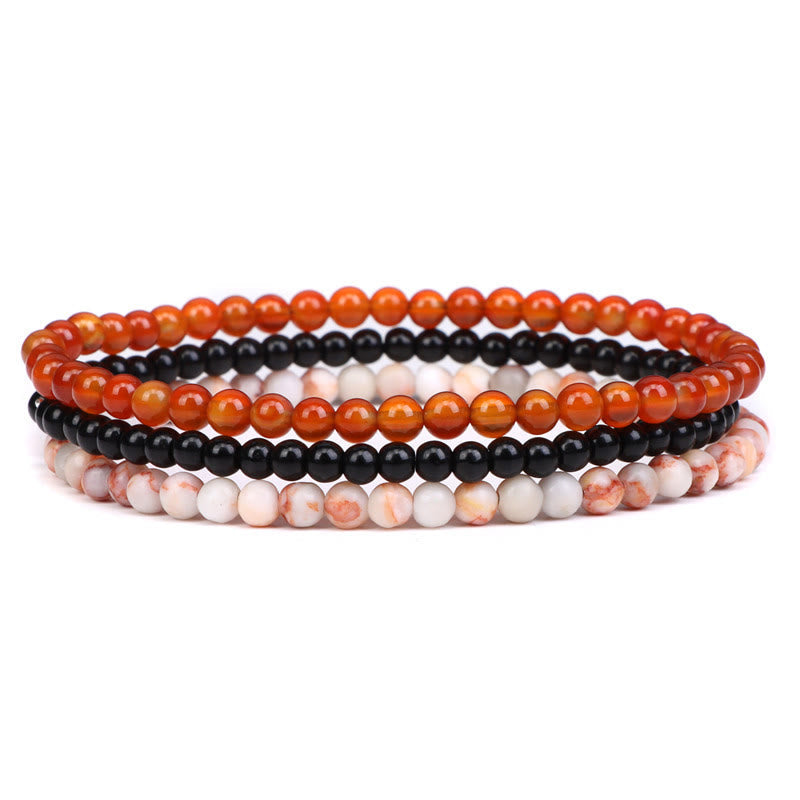 Armband Kristall – Frieden drei Stränge orange schwarz weiß Perlen