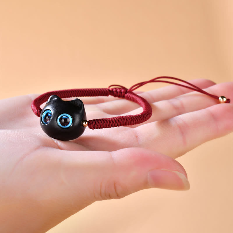 Armband Ebenholz Katze mit blauen Augen elastisch Handgelenk getragen Frieden