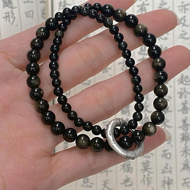 Schwarzer Obsidian Armband 925 Silber an Hand getragen Naturstein