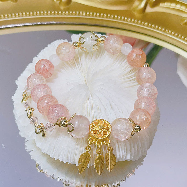 Roségold Armband mit Rosenquarz Perlen und goldenem Traumfänger Anhänger