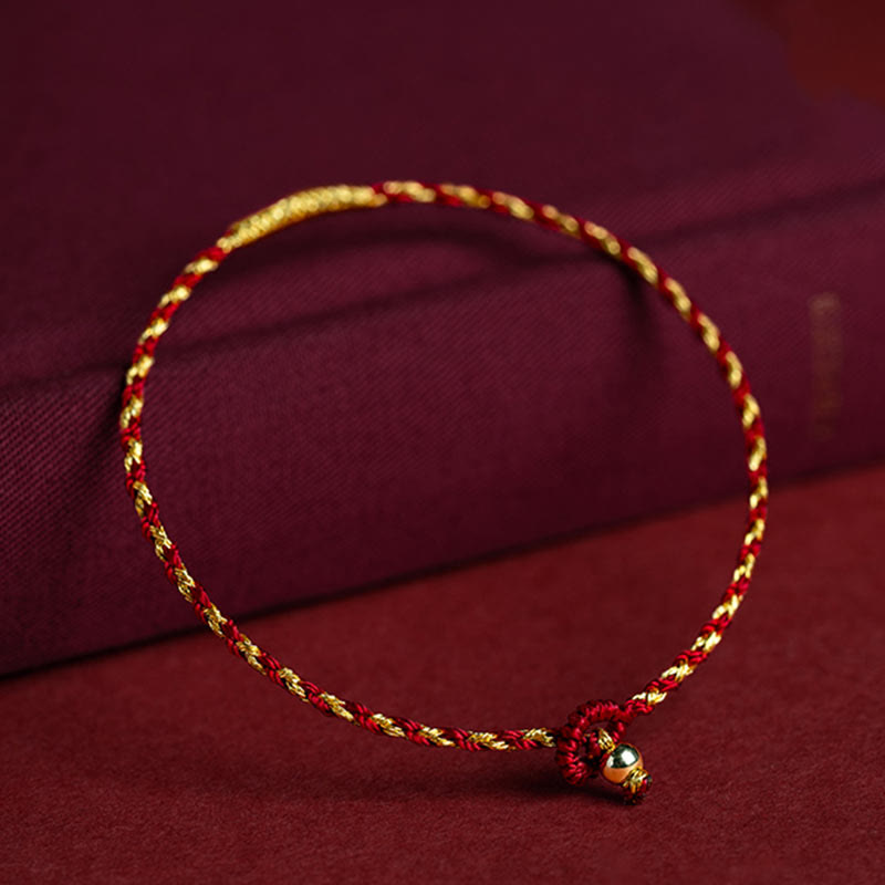 Rotes goldenes geflochtenes Armband mit Knoten Glücksbringer eleganter Schmuck