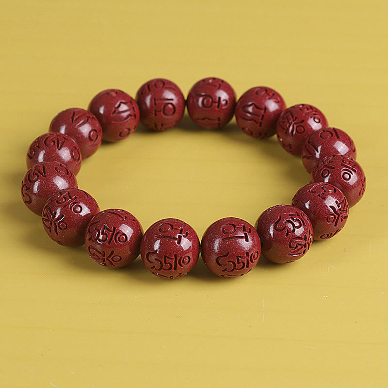 Zinnober Armband mit Om Mani Padme Hum Gravur auf gelbem Hintergrund