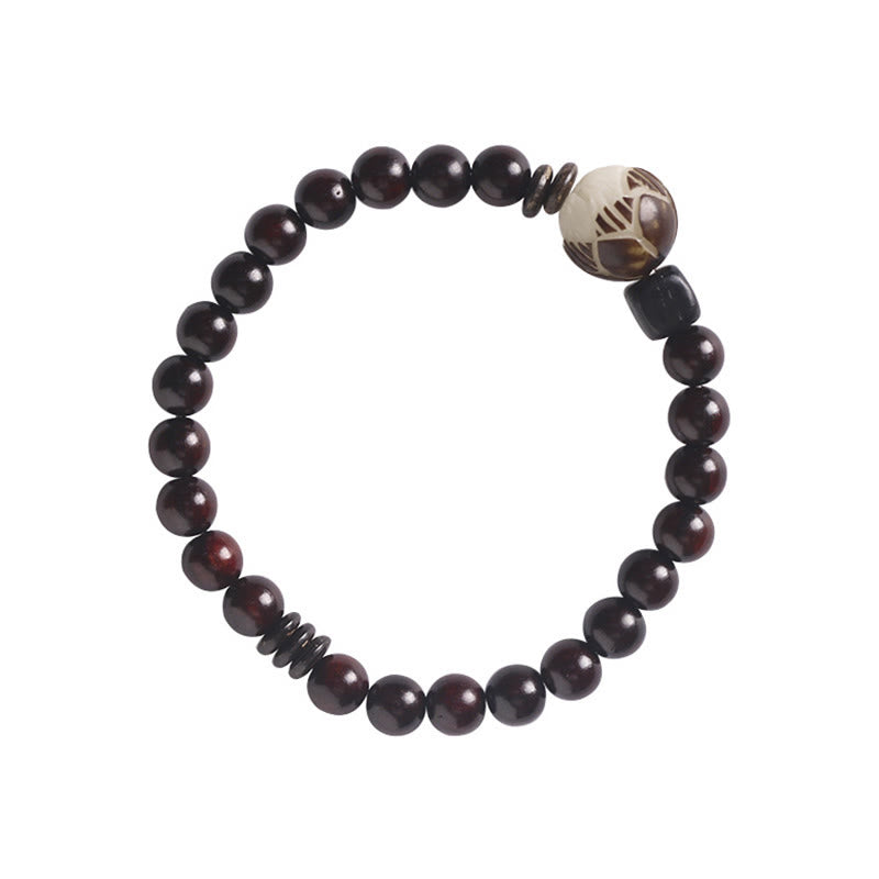Sandelholz Bodhi Lotus Armband mit schwarzen Perlen elastisch getragen