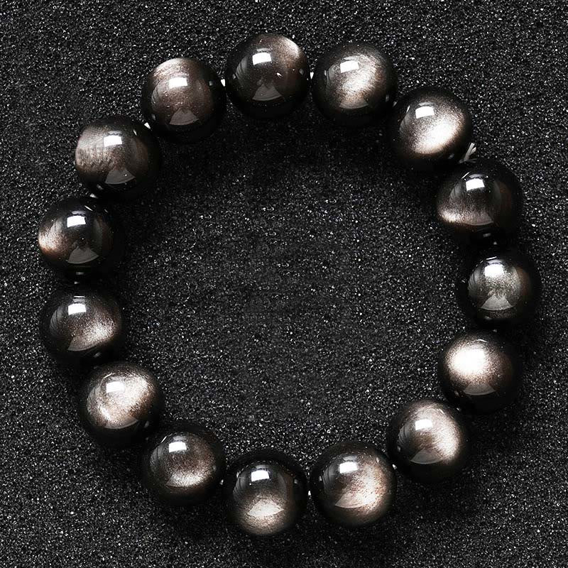 Armband Silber Obsidian – Schutz glänzende schwarze Kugeln auf dunklem Hintergrund
