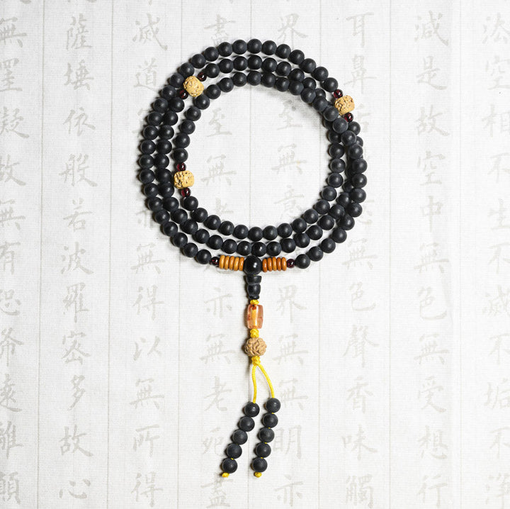 Schwarze Mala mit goldenen Perlen, Flachaufnahme auf chinesischem Hintergrund, Heilung
