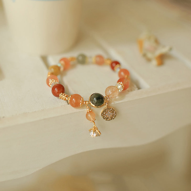 Armband Stern – Wohlstand mit orangefarbenen Steinen und Golddetails.