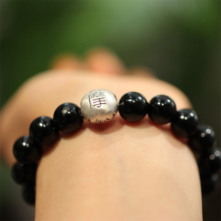 Schwarzes Onyx Armband mit Silberperle am Handgelenk getragen elegant