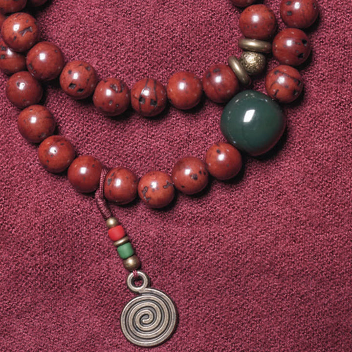 Rotes Armband mit Jade Anhänger und Spirale Glück Frieden