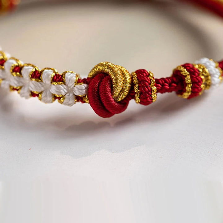 Armband Pfirsichblüte Glück Liebe mit roten weißen goldenen Fäden handgefertigt