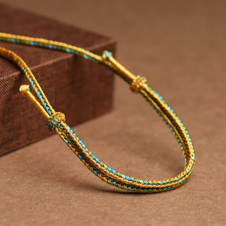 Geflochtenes Armband gold türkis Glücksknoten verstellbar