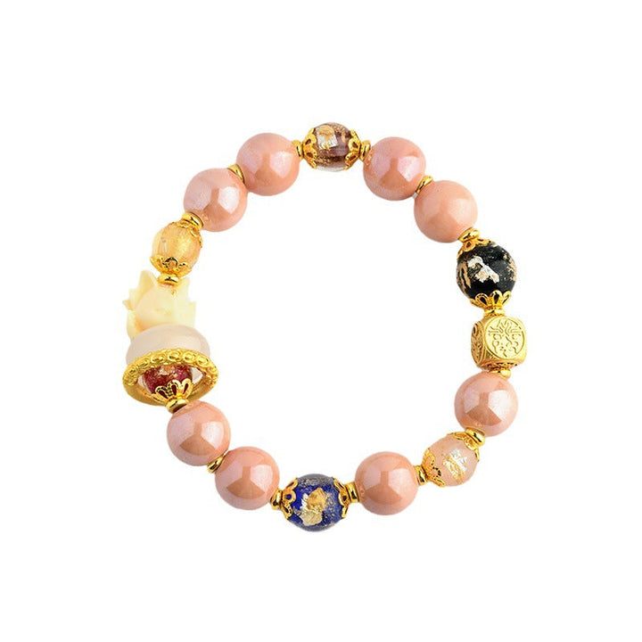 Armband Fuchs mit Rosenquarz Perlen und goldenen Akzenten elegant.