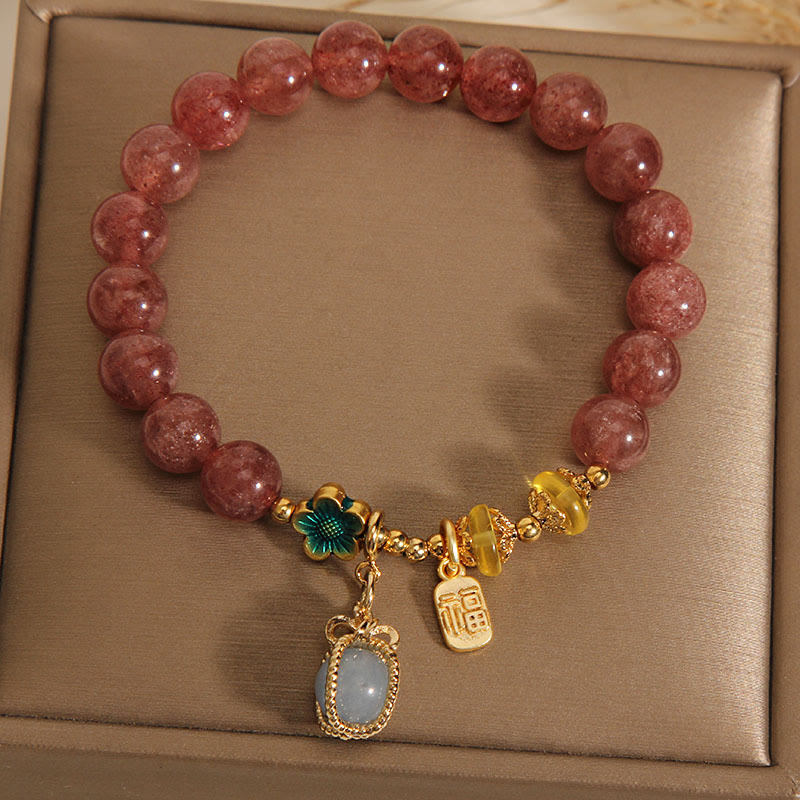 Armband Erdbeerquarz Aquamarin goldene Verzierungen elegantes Schmuckstück Naturstein.