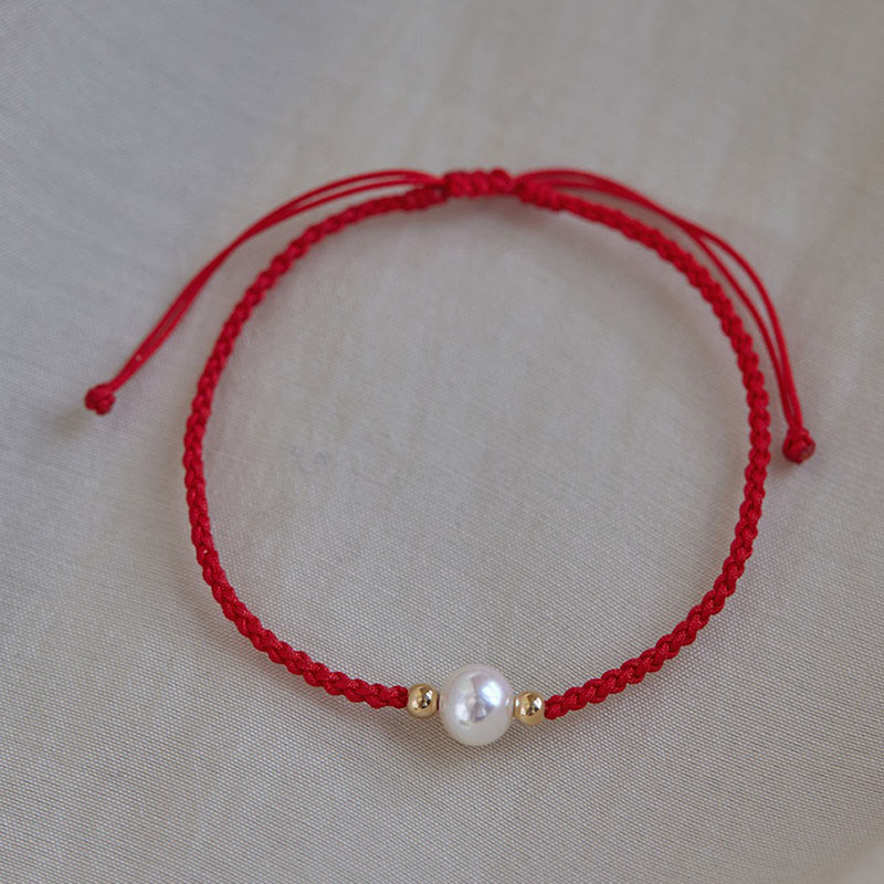 Rotes geflochtenes Armband Naturperle mit goldenen Perlen Glück Energie