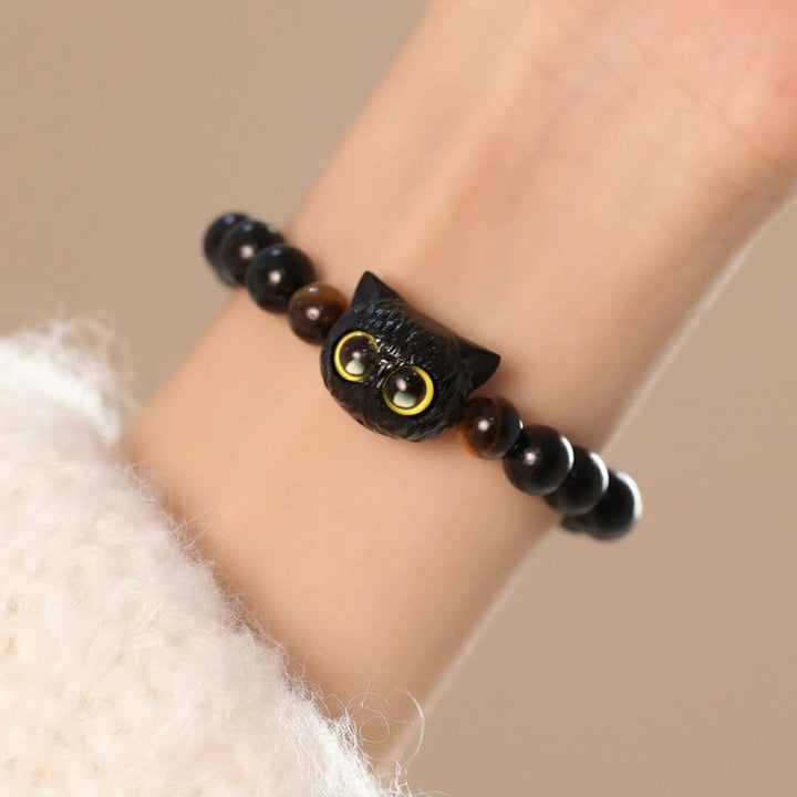 Armband Ebenholz Katze schwarze Perlen gelbe Augen elastisch getragen