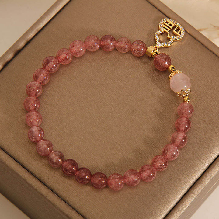 Armband Erdbeerquarz Fu-Zeichen rosafarbene Perlen Naturstein elegant.