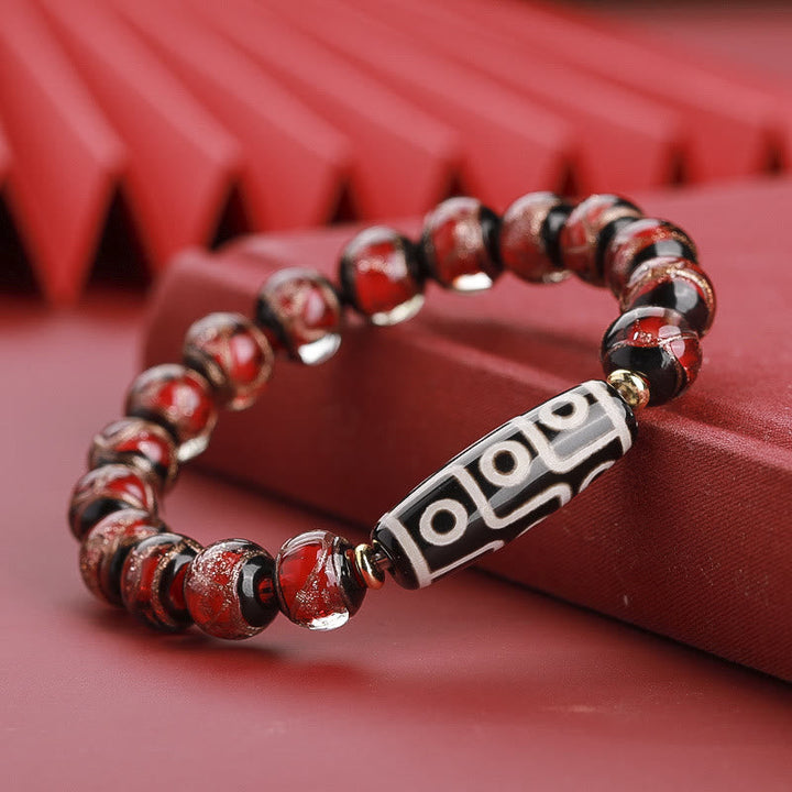Rotes Armband – Wohlstand Balance mit schwarzem Tibetan-Dzi-Stein elegant.
