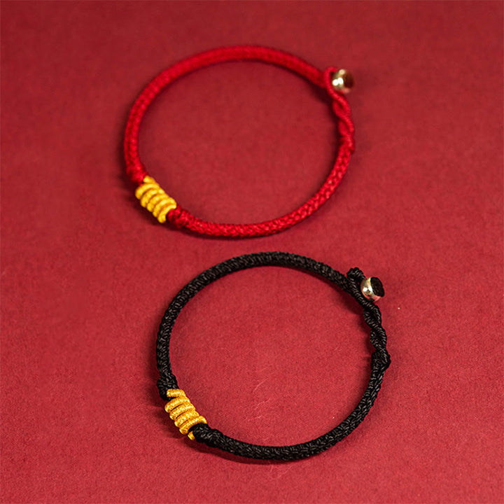 Rotes und schwarzes Armband mit goldenen Perlen Schutzenergie