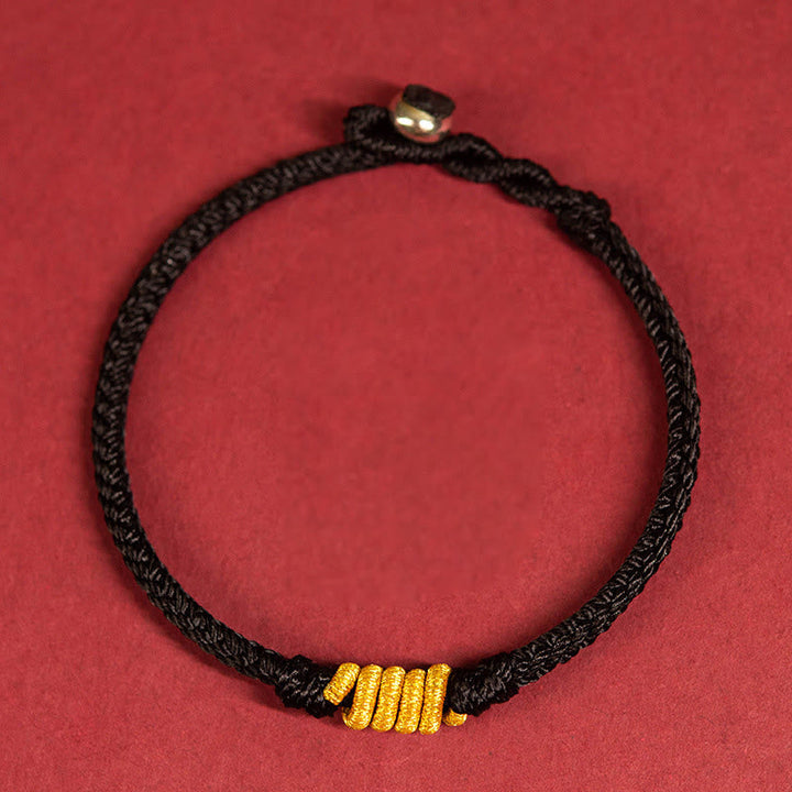 Schwarzes geflochtenes Armband mit goldenen Perlen Schutz Glück Energie