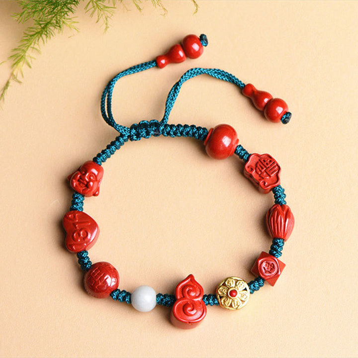 Rotes Zinnober Armband mit blauer Kordel und Om Mani Padme Hum Perlen elastisch.