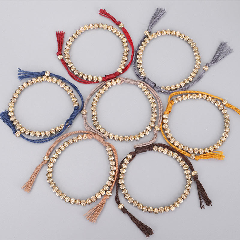 Acht goldene Perlen-Armbänder mit farbigen Quasten Armband Kupfer – Glück Balance
